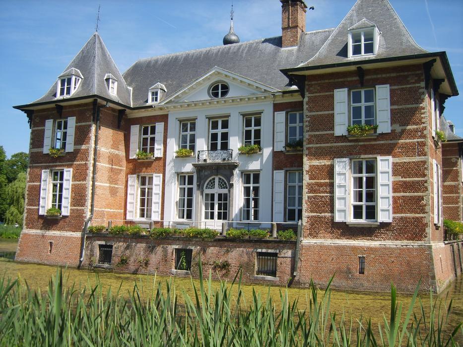 historic brick building at water, belgium