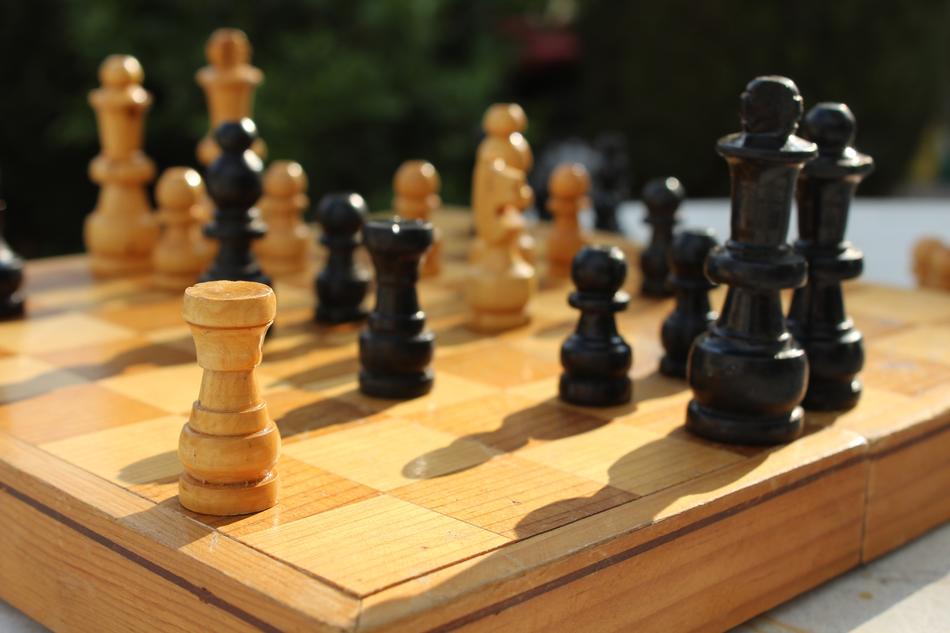 wooden chess pieces on the board
