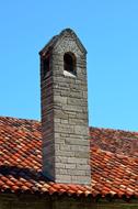 antique stone chimney and roof tiles