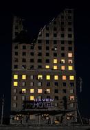 sea view hotel, partly abandoned building at night