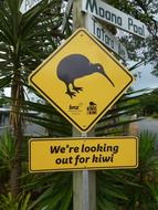 yellow sign with a bird
