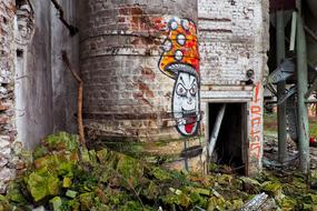 graffiti on chimney of abandoned factory