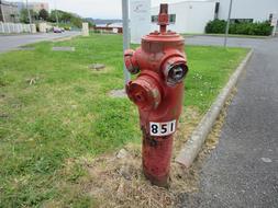 old red hydrant by the grass