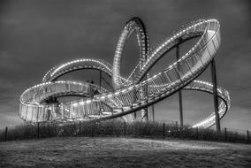 photo of a twisted bridge with lamps