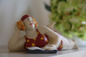 Figure of a woman resting on the beach