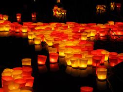 burning candles floating in the river