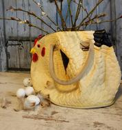 Easter decoration of Ladyâs Handbag in shape of hen and eggs