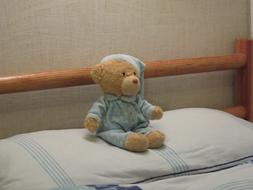 teddy bear in pajamas on the bed