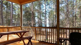 porch with table and bench for a picnic in the woods