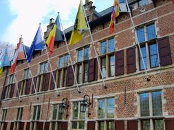 flags on the facade of the building in antwerp