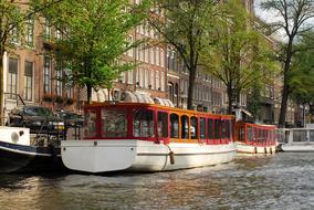 Beautiful canal with the trees along in Amsterdam, Netherlands