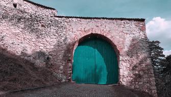 turquoise gate in a medieval castle in Romania