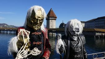 people at the festival in costumes with masks