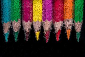 colored pencils in water with bubbles
