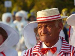 Old Man in straw hat on Carnival close-up