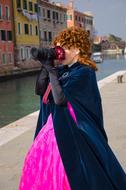 girl in a beautiful dress taking pictures of the city