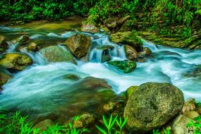 waterfall against a backdrop of rocks with moss