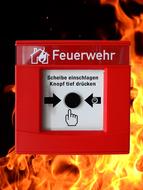 "Push button" for fire alarm, at black background with flame