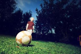 Child Football on green grass