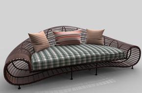 designer wicker sofa with three pillows on white shining surface