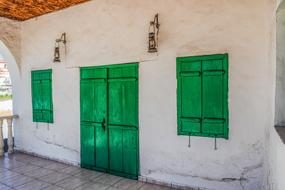 green shutters and door in a building in Avgorou, Cyprus