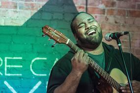 Musician, young man plays Guitar and Sings