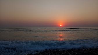 red sun by the sea