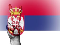 victory hand gesture at flag of Serbia, patriotic banner