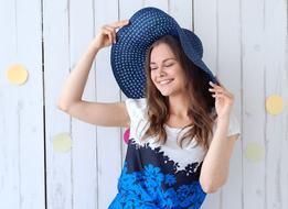 joyful girl in a blue hat
