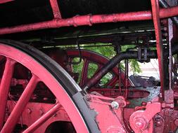 Close-up of the vintage, red and black locomotive, with the wheels