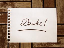 writing on paper on a wooden wall