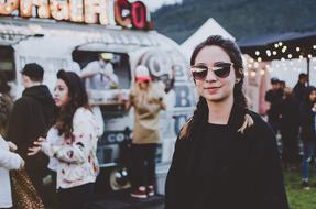 Woman in sunglasses among other people