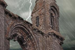 lightning in a stormy sky over stone ruins