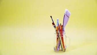 paintbrushes in a glass