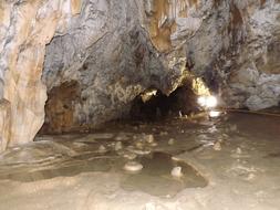 cave with rock outcrops and a river