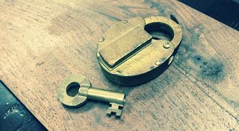 iron lock with a key on the table