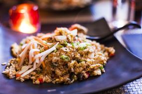 fried rice with vegetables in front of the fire