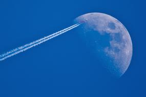 airplane flying over the moon