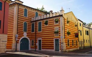 photo of an orange striped facade of a building in Italy