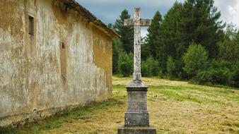 stone Cross near Old Building