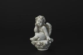 stone figure of an angel on a black background