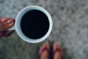 man is holding hot coffee