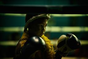 child wearing boxing gloves