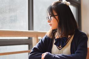 cute girl with glasses by the window