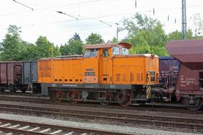 orange diesel locomotive on the railroad