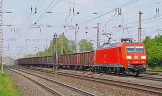 orange train on the railroad tracks