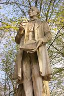 sculpture of a man near a tree