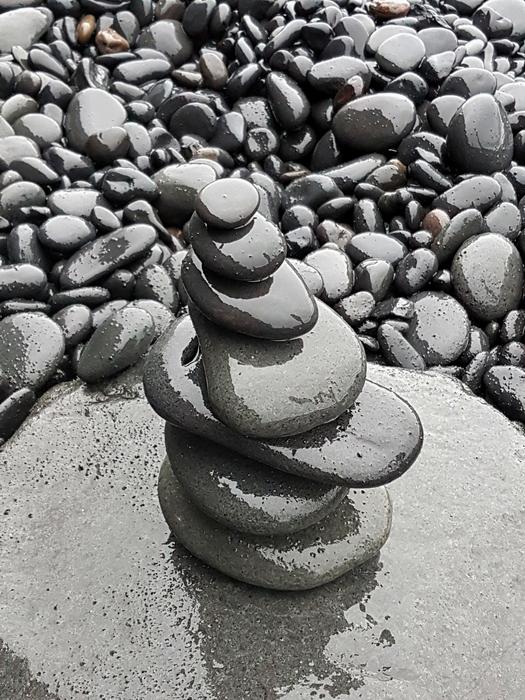 Gray rocks on the beach lined up on top of each other free image download