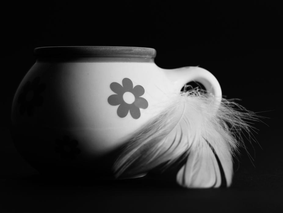 mug with a flower decorated with a feather