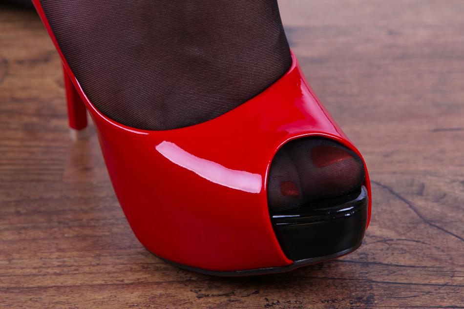 a woman's foot with a pedicure in a red shoe